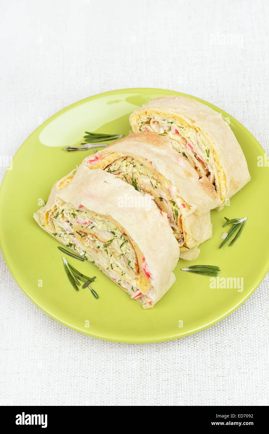 Lavash rolls with crab meat, cheese, eggs and herbs on green plate, top view Stock Photo Alamy