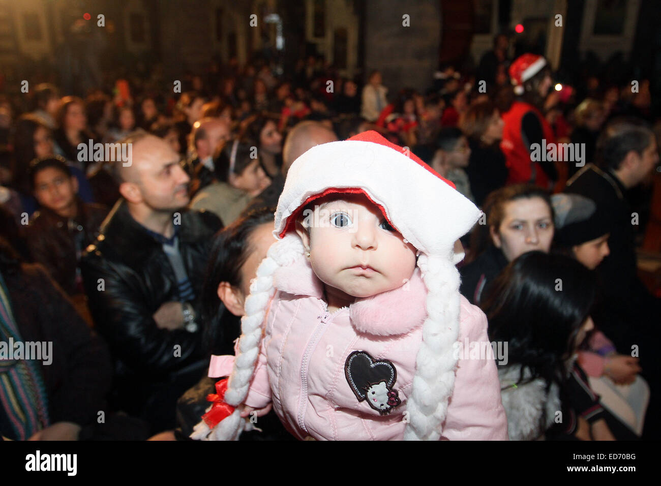 Damascus, Syria. 30th Dec, 2014. A baby attends the Christmas celebration at al-Zaitoun Cathedral in Damascus, capital of Syria, on Dec. 30, 2014. About 1,500 Syrian Christian kids and their parents gathered at al-Zaitoun Cathedral in Syria's capital Damascus to take part in a Christmas celebration. About 10 percent of population in Syria are Christian, who suffered persecution in some parts of the country by the hands of the extremist groups. © Bassem Tellawi/Xinhua/Alamy Live News Stock Photo