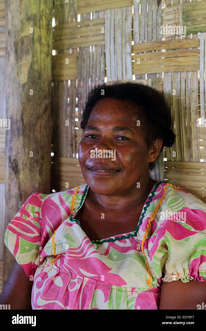 LONORORE,VANUATU-OCTOBER 15, 2014: Smiling lady selling vegetables and local food in a post Lonorore Airport on October 15, in P Stock Photo