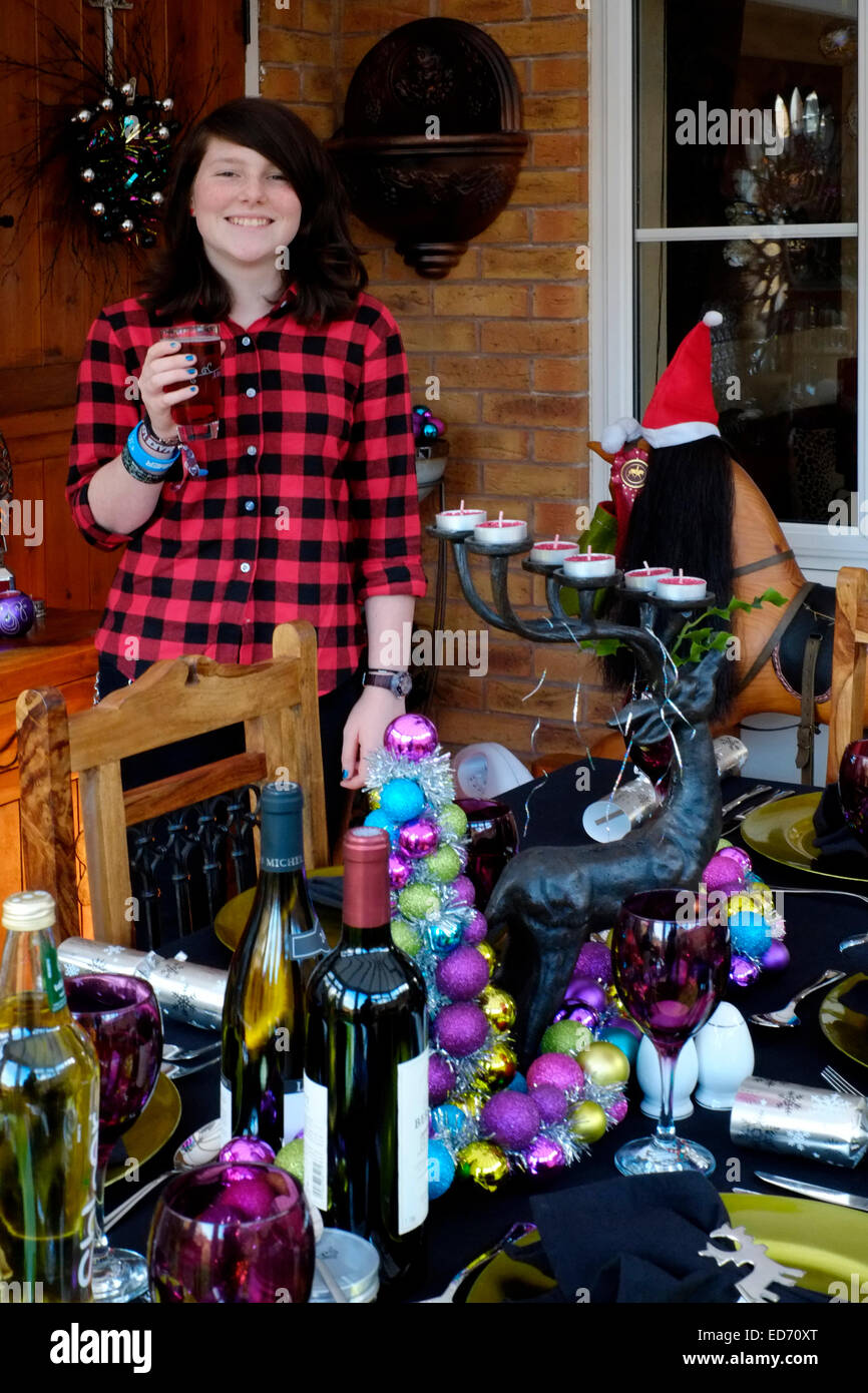 twelve year old girl with soft drink waiting for christmas dinner to be