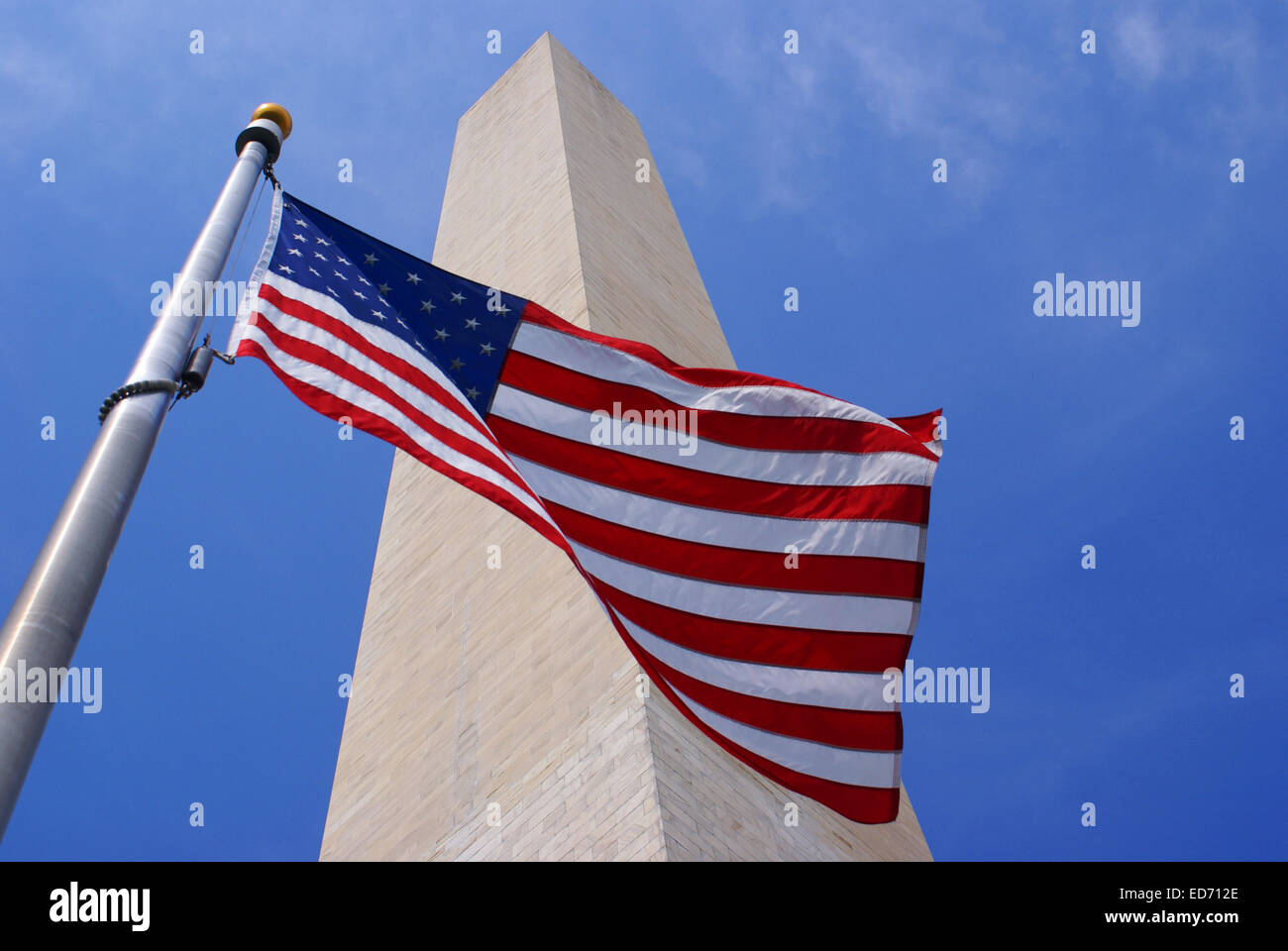 A picture of the American flag with the Washington Monument in the Background Stock Photo