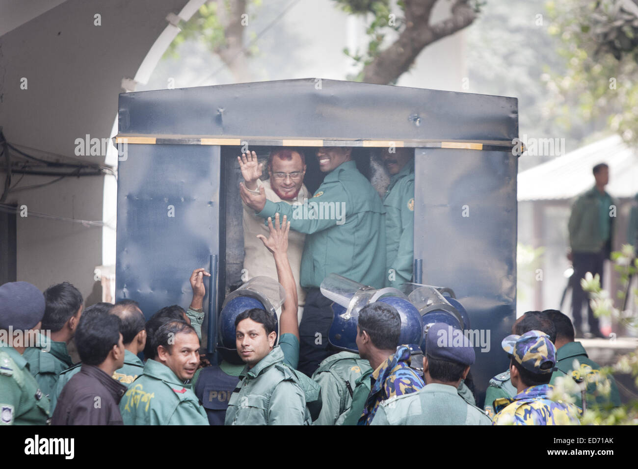 Dec. 30, 2014 - Dhaka, Bangladesh - Al-Badr commander ATM Azharul Islam, a senior leader of the Bangladesh's largest Islamist party Jamaat-e-Islami waves his hand as he enters a police van after a special tribunal sentenced him to death for mass murder during the nation's 1971 independence war against Pakistan. (Credit Image: © Suvra Kanti Das/ZUMA Wire/ZUMAPRESS.com) Stock Photo