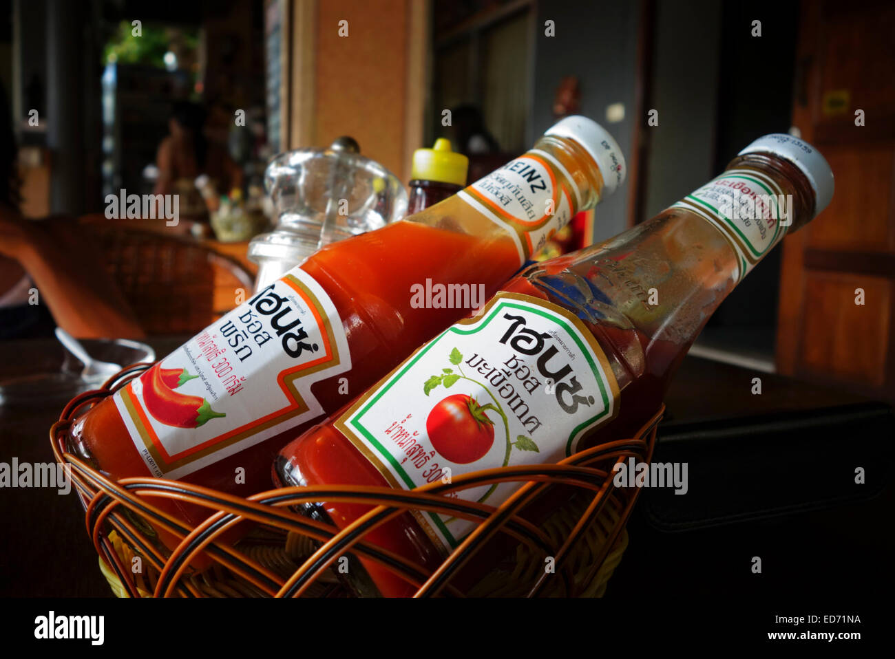 Heinz Tomato Ketchup and chili sauce in basket. Thai language. Thailand. South-east Asia. Stock Photo