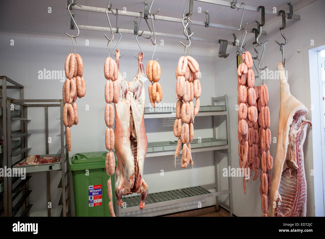 Meat hanging in a butchers Stock Photo