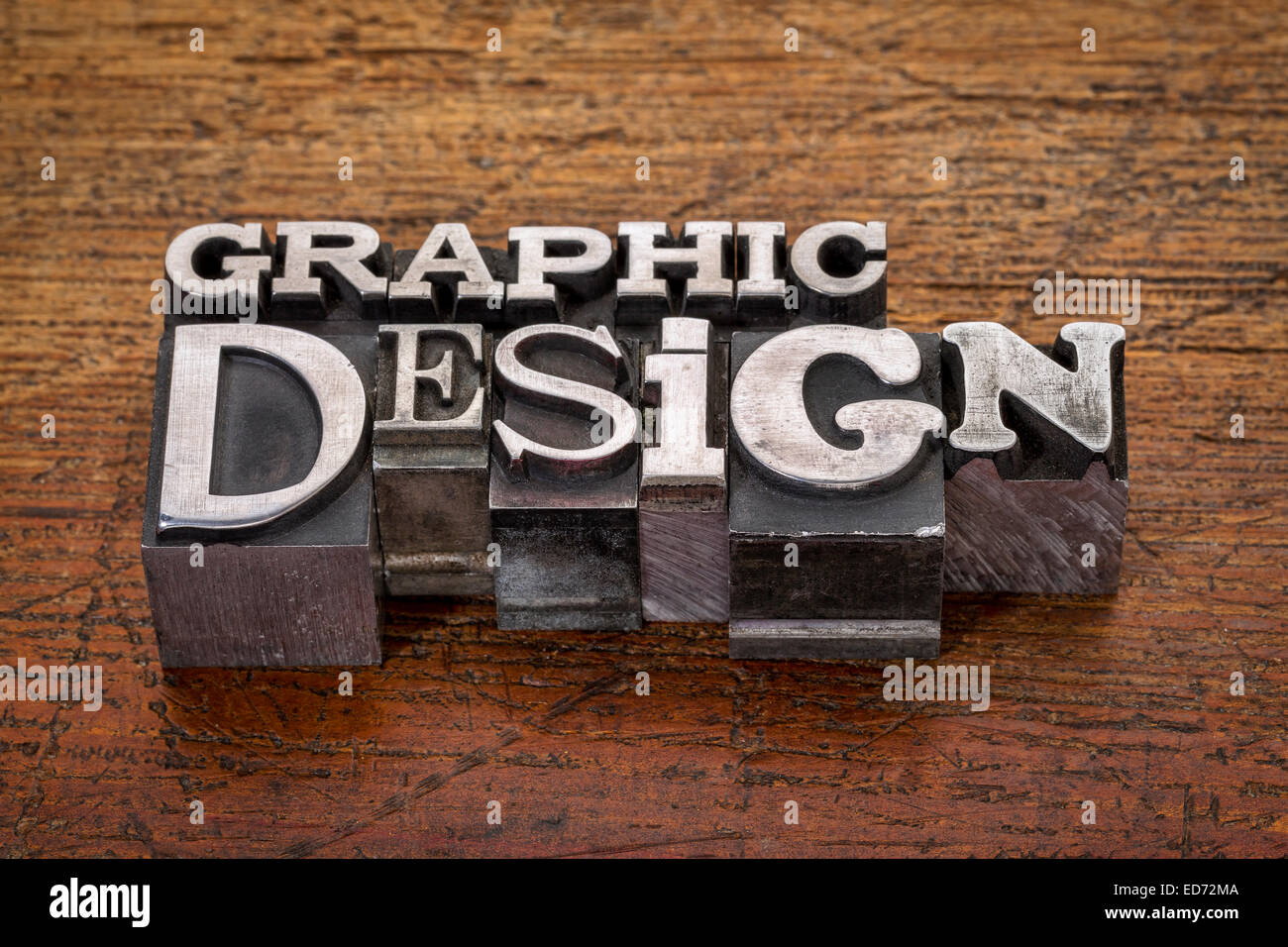 graphic design text in mixed vintage metal type printing blocks over grunge wood Stock Photo
