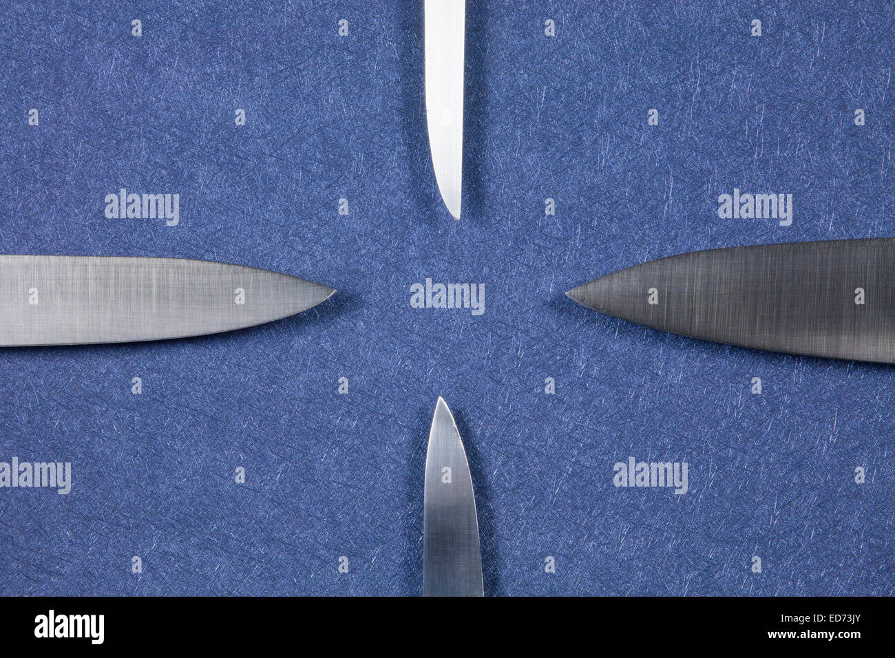 four big kitchen knife bright silver blades on blue background Stock Photo