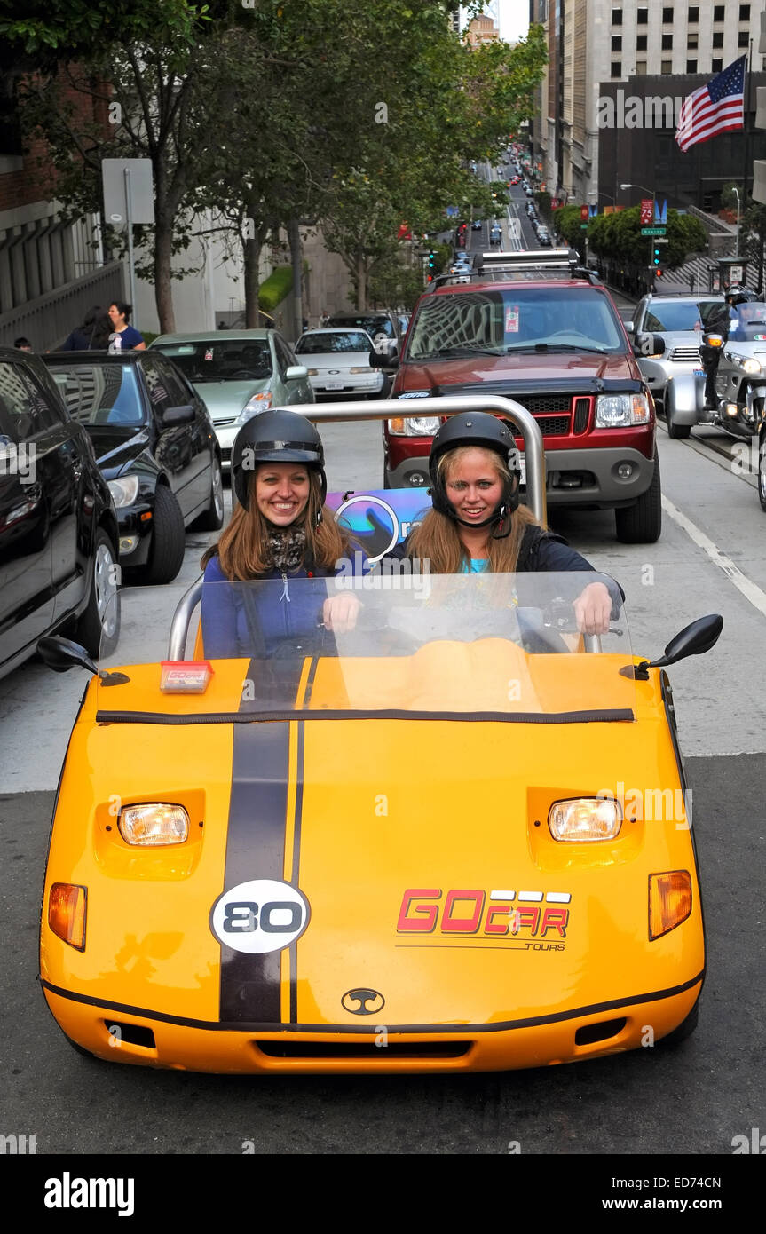 two young drivers smile in aGo car in San Francisco, USA Stock Photo