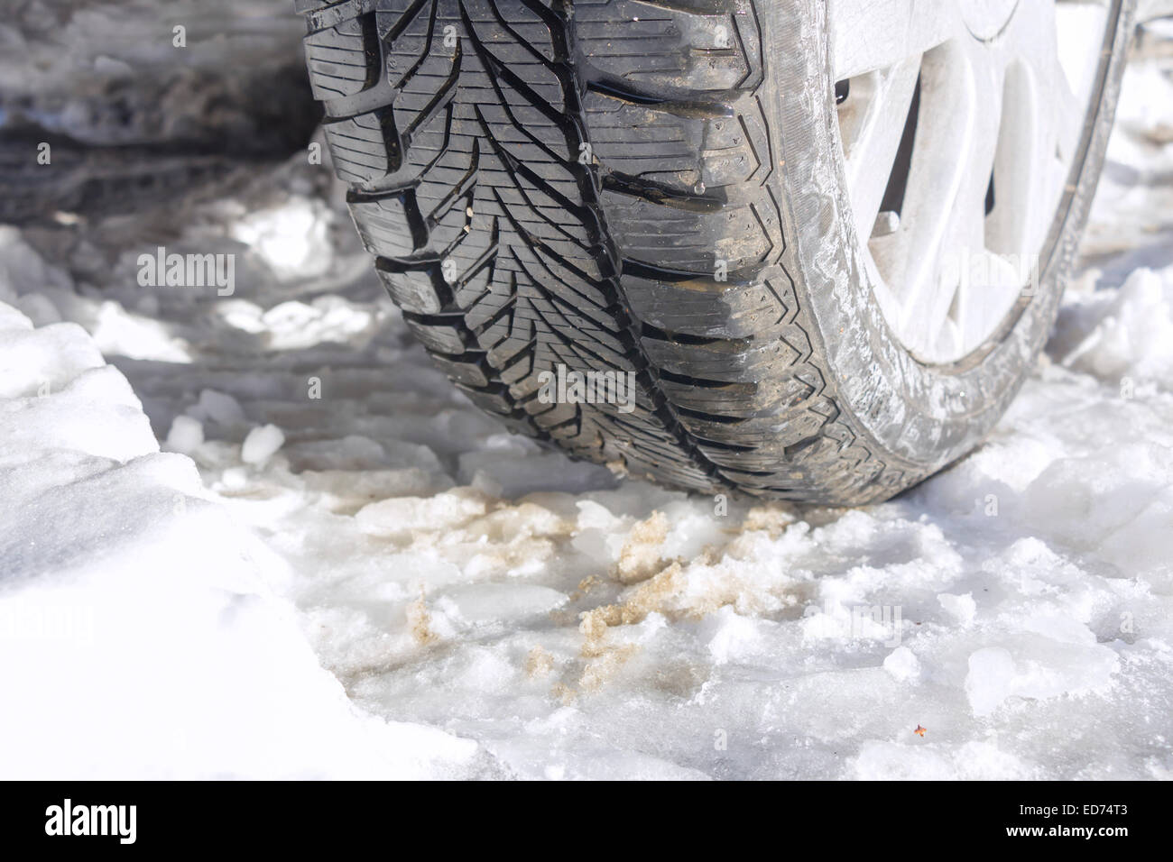 Winter tyres of a cars on a snowy road Stock Photo