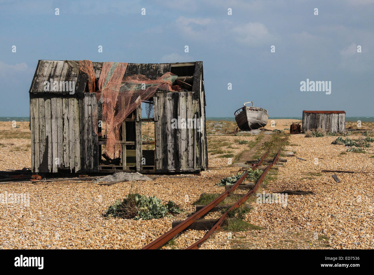 Derelict sheds and on the shingle at Dungeness, Britain's only desert. With the tracks for an old small railway. Stock Photo