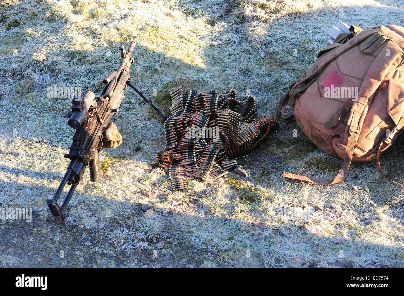 A 5.62mm Minimi light machine gun with ammunitions by its side. Stock Photo