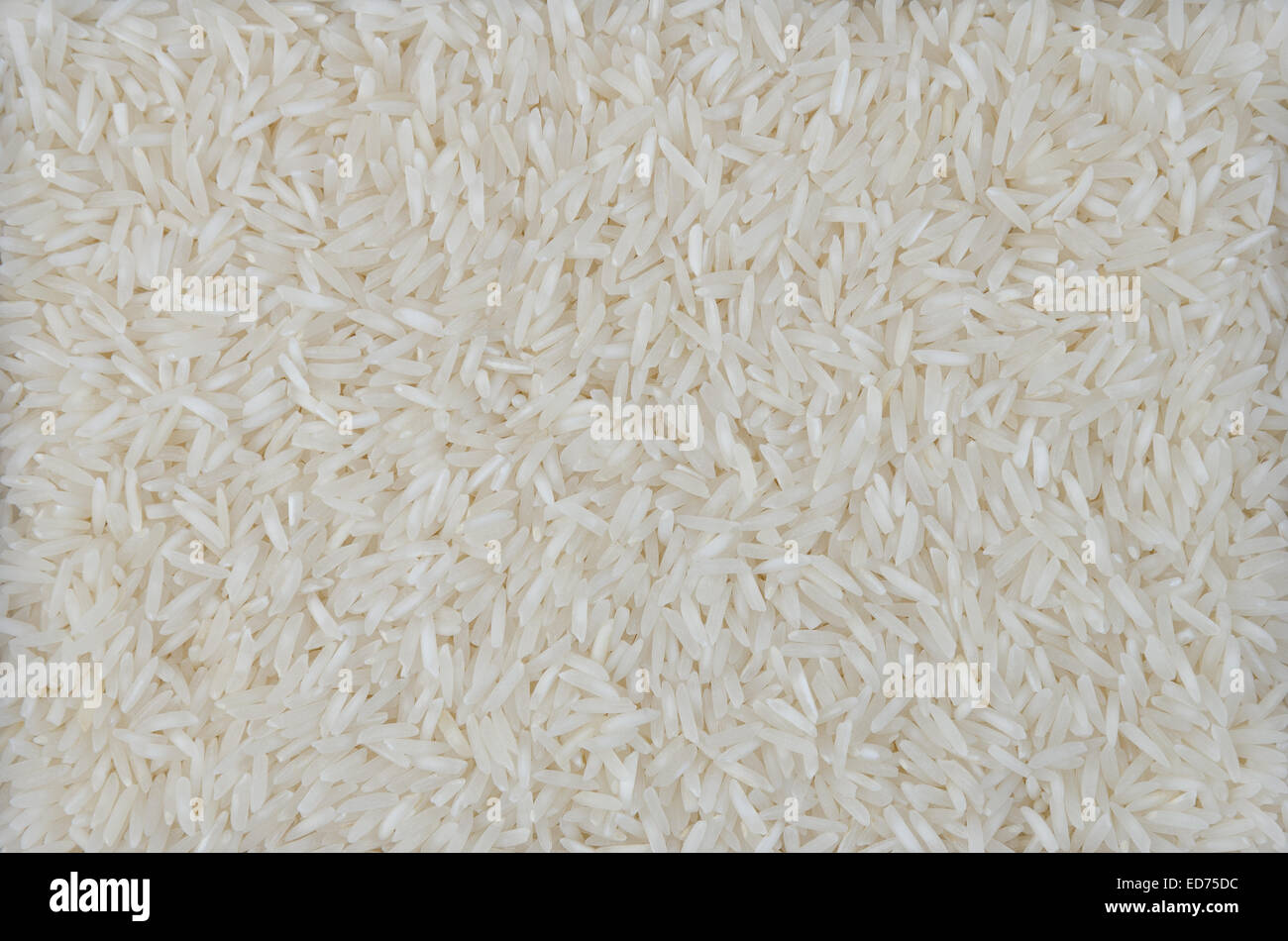 Basmati Rice Background. Processed basmati rice on a straight surface coated, usable as background. Stock Photo