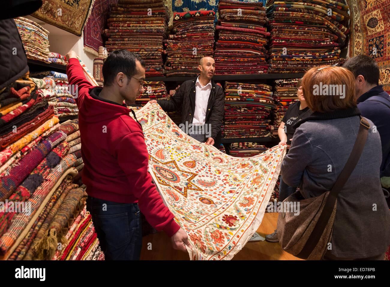 Salesman with traditional Turkish carpet rug in The Grand Bazaar