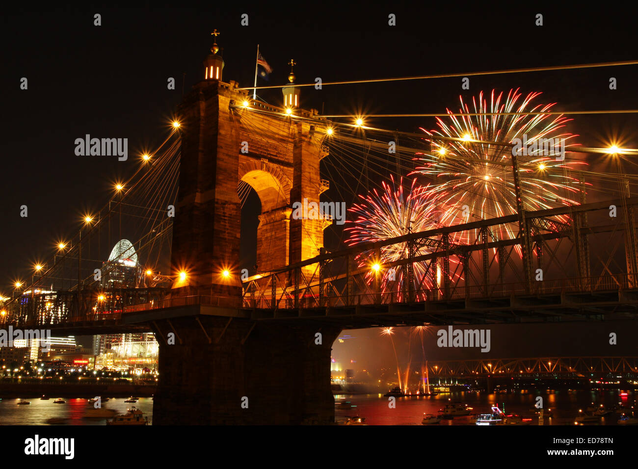 John A. Roebling Suspension Bridge with fireworks in the background and with Cincinnati, Ohio in the background. The bridge span Stock Photo