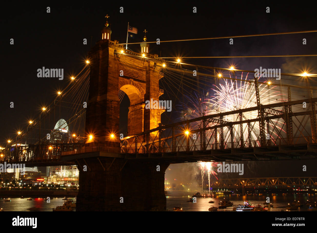 John A. Roebling Suspension Bridge with fireworks in the background and with Cincinnati, Ohio in the background. The bridge span Stock Photo