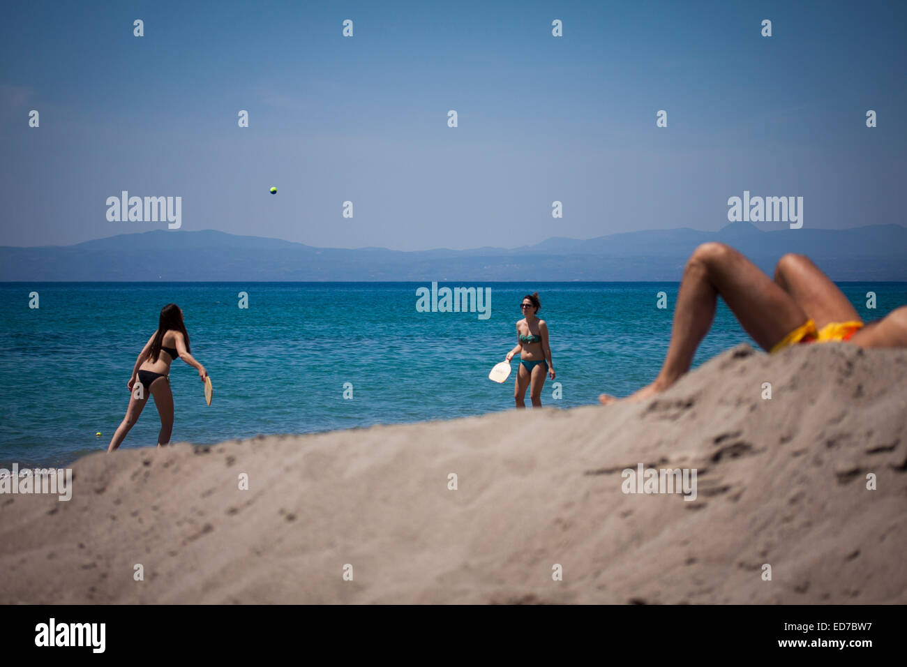 Two girls playing rackets on Santova beach. Kalamata, Messenia, Peloponnese, Greece Stock Photo