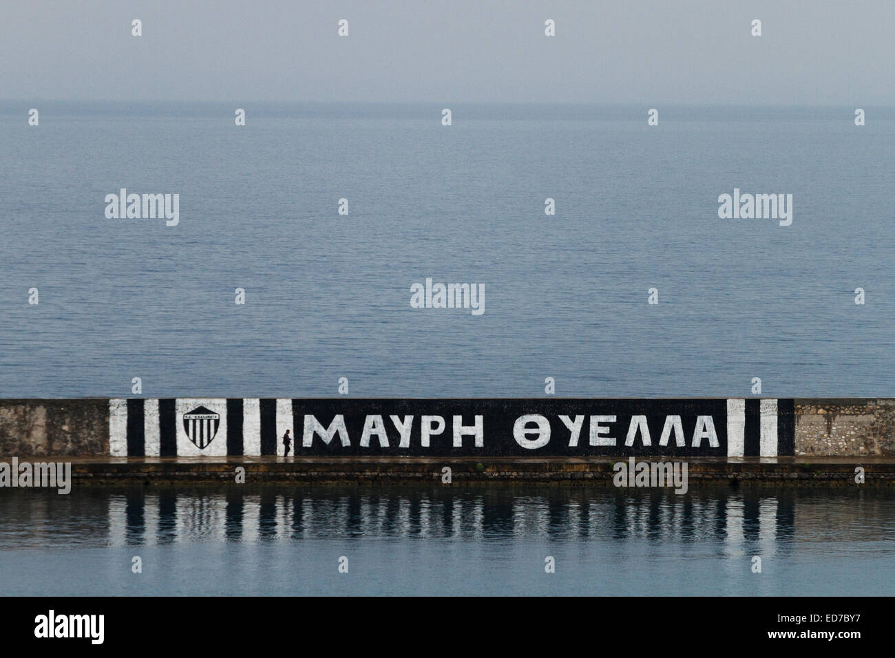 Footbal slogan (Black Storm) painted on the jetty of Kalamata's harbour. Messenia, Peloponnese, Greece Stock Photo