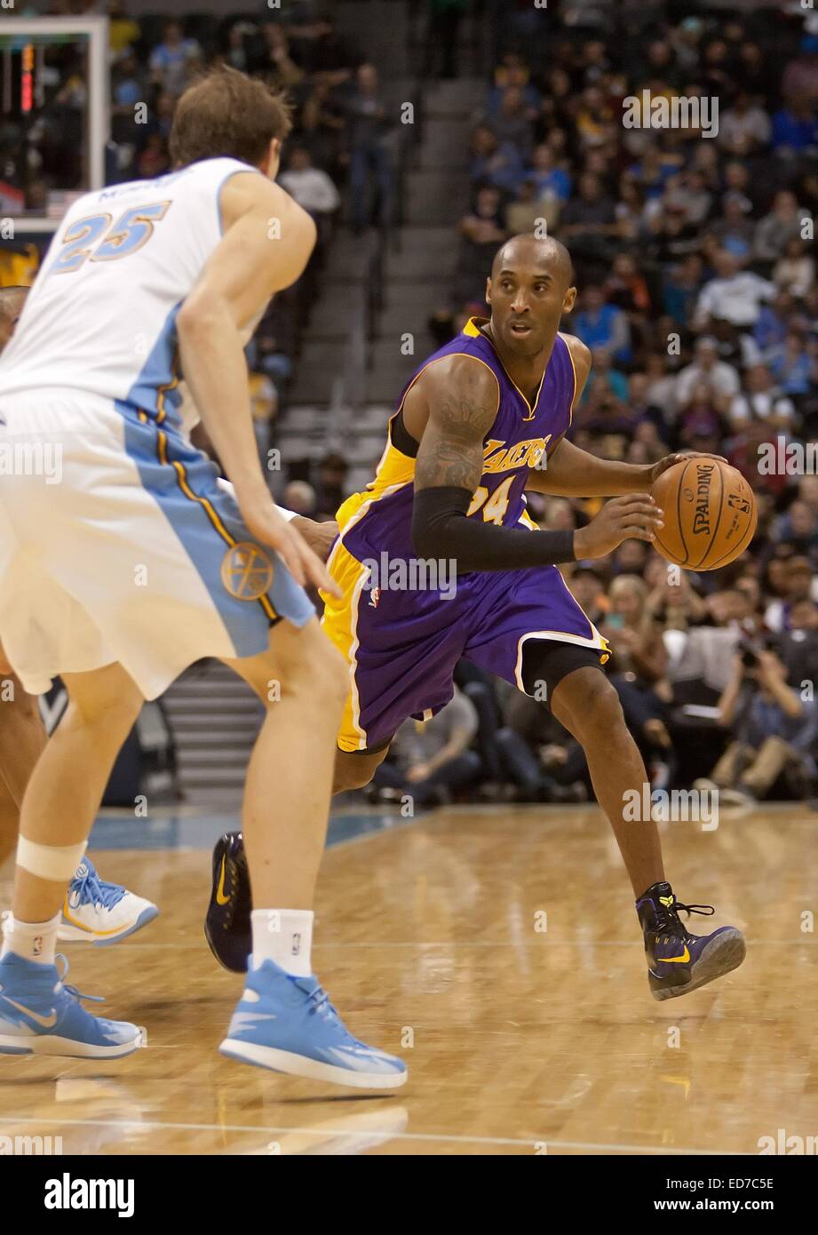 Denver, Colorado, USA. 30th Dec, 2014. Lakers KOBE BRYANT, right, dribbles the ball to center court with Nuggets TIMOFEY MOZGOV, left, guarding him during the 3rd. Quarter at the Pepsi Center Tues. night. The Lakers beat the Nuggets 111-103 Credit:  Hector Acevedo/ZUMA Wire/Alamy Live News Stock Photo