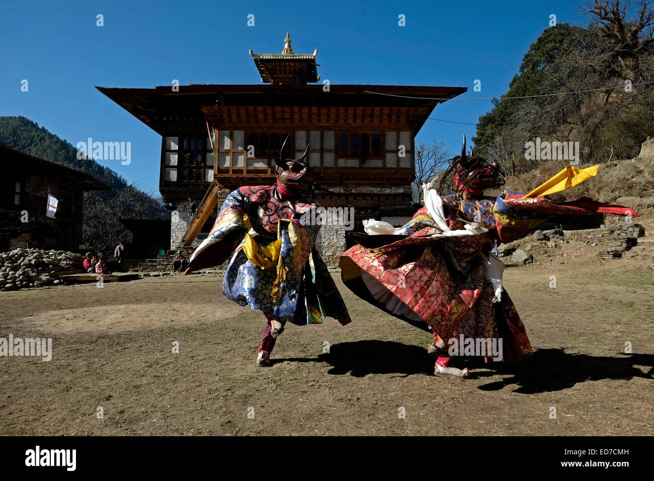 Masked dancers taking part in a rare and old sacred dance called Zhey not performed elsewhere in Bhutan during the annual religious Bhutanese Tshechu festival in Ngang Lhakhang a Buddhist monastery also known as the 'Swan temple' built in the 16th century by a Tibetan lama named Namkha Samdrip in the Choekhor Valley of Bumthang District central Bhutan Stock Photo