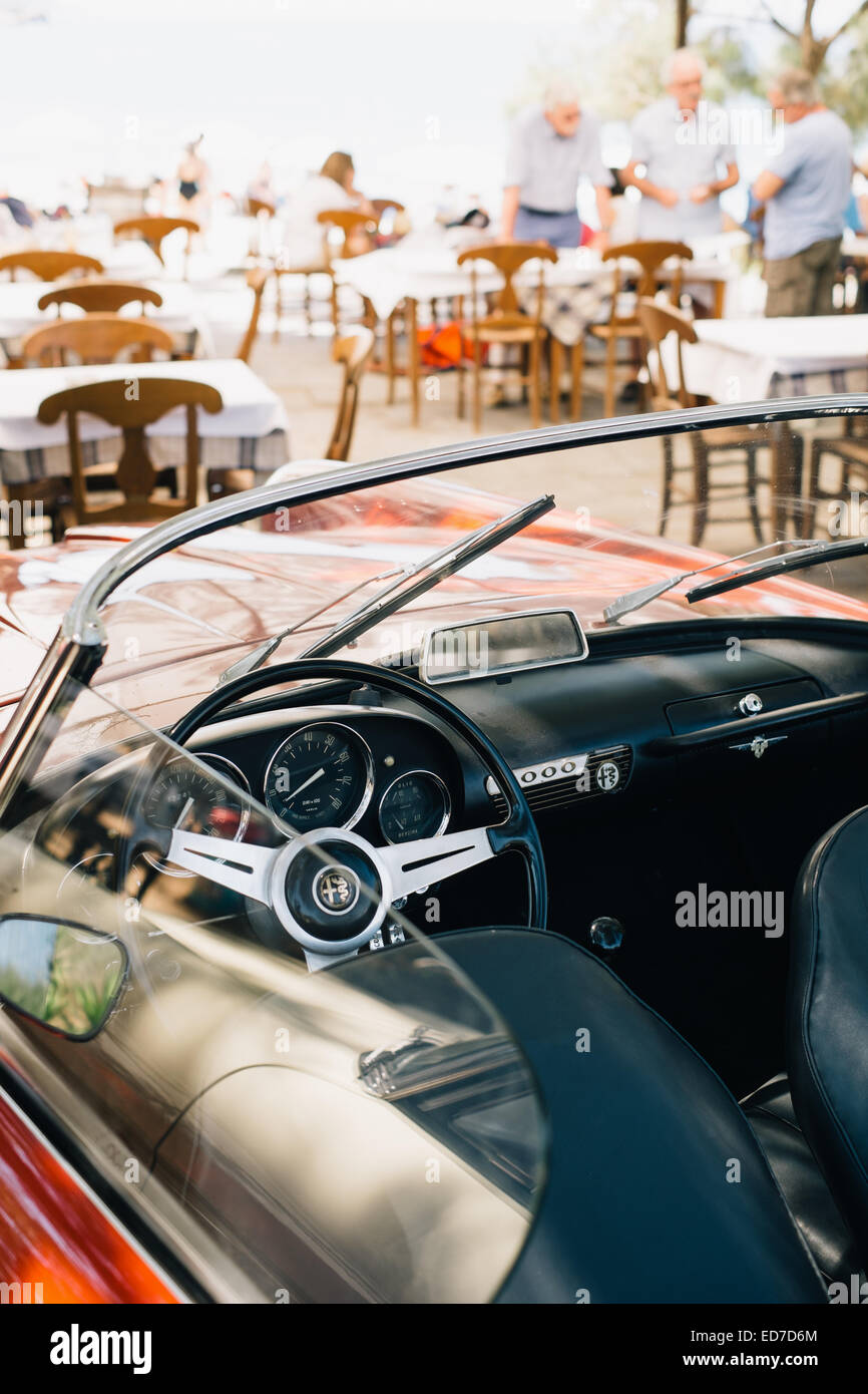 Classic convertible open top Alfa Romeo sports car - parked at a beach restaurant - Mani Peninsula, Peloponnese, Greece Stock Photo