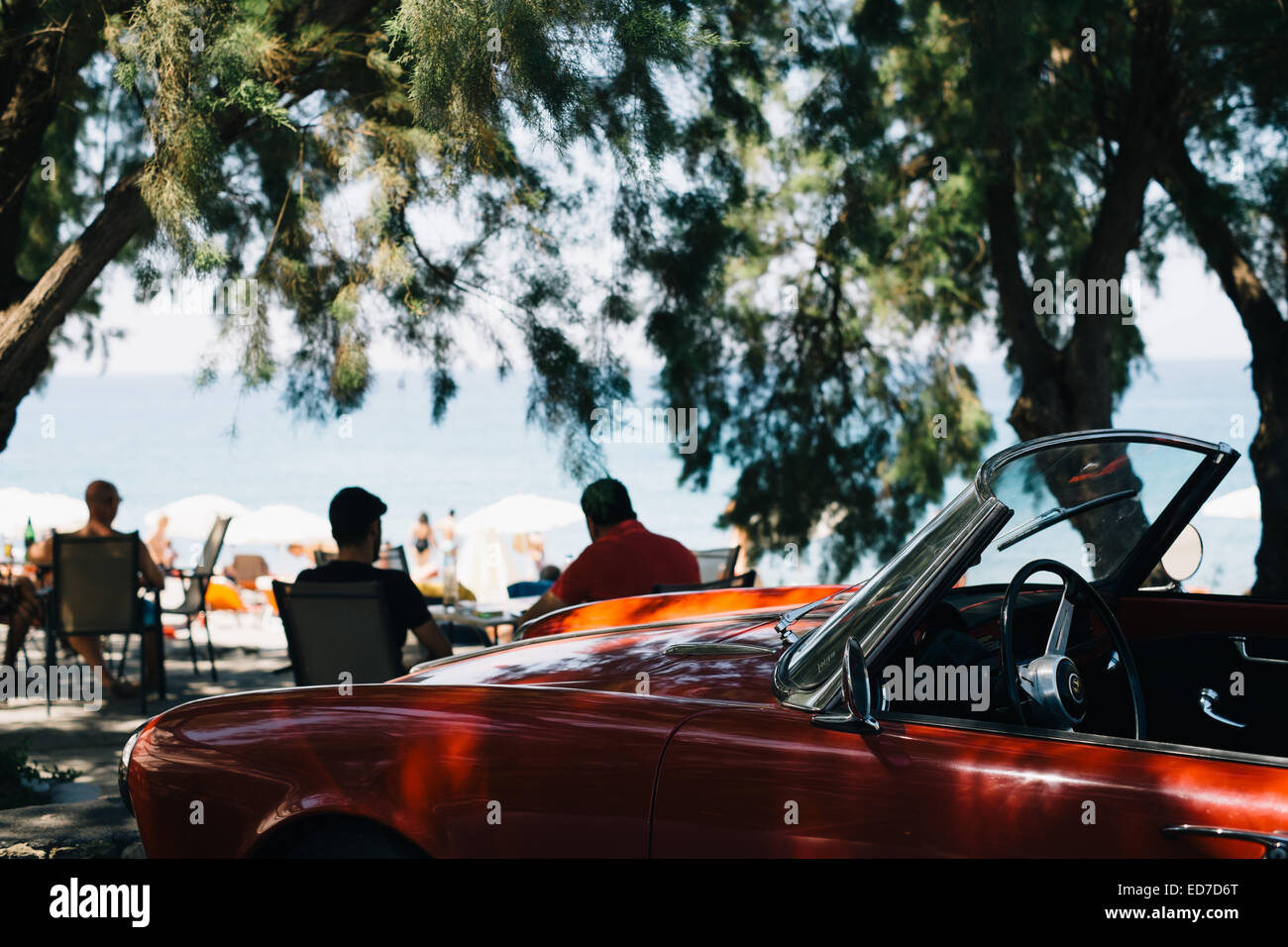 Classic convertible open top Alfa Romeo sports car - parked at a beach - Mani Peninsula, Peloponnese, Greece Stock Photo
