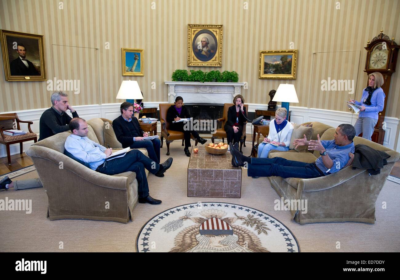 US President Barack Obama talks with national security advisors before ...
