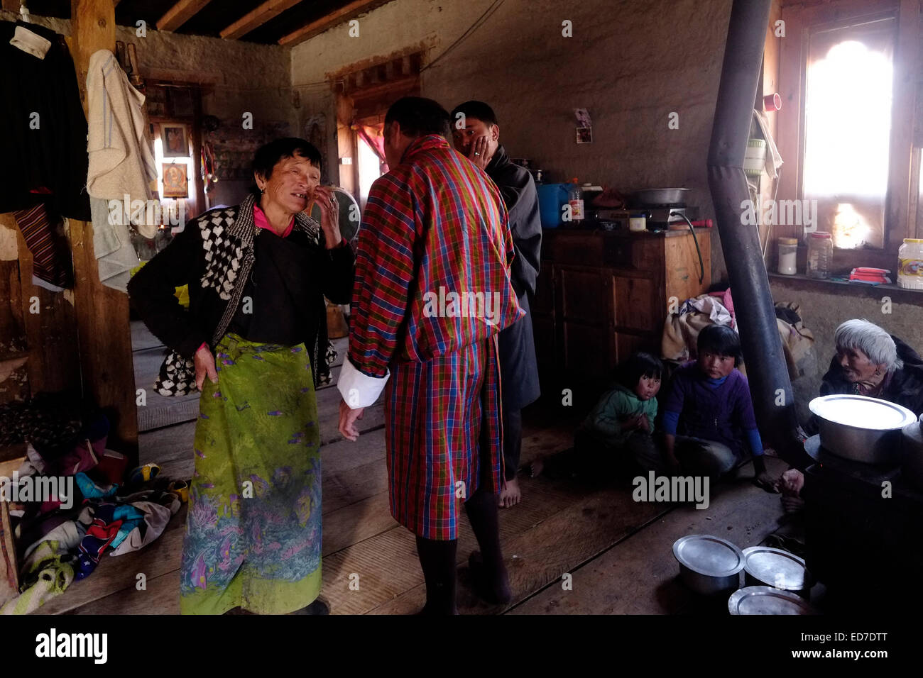 Residents gathered in a house in the village of Ogyencholing or Ogyen choling in Tang valley in Bhutan Stock Photo