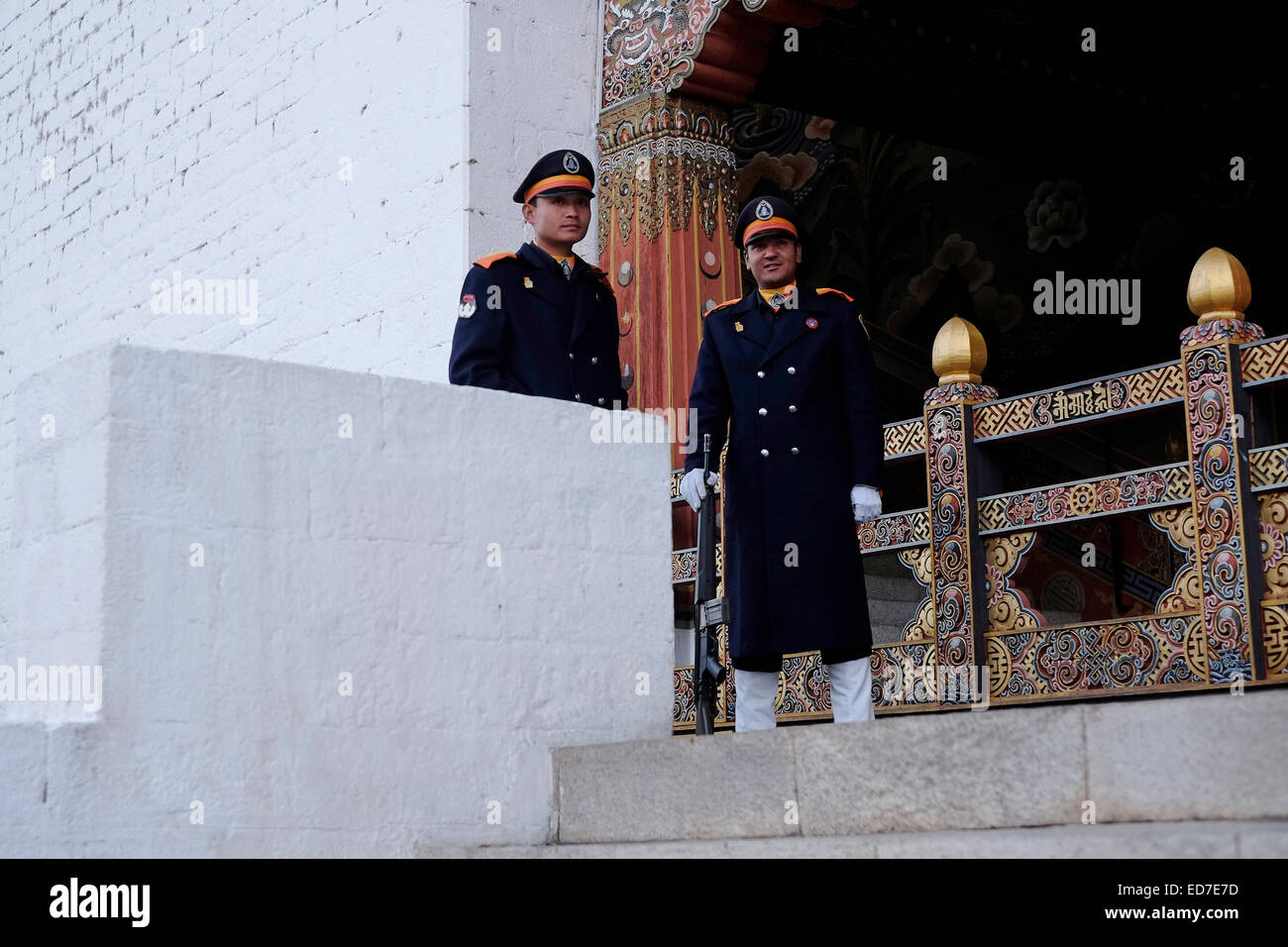 Armed sentries at the entrance to the government offices in Tashichho Dzong fortress seat of Bhutan's government since 1952 and presently houses the throne room and offices of the king on the edge of the city of Thimphu the capital of Bhutan Stock Photo
