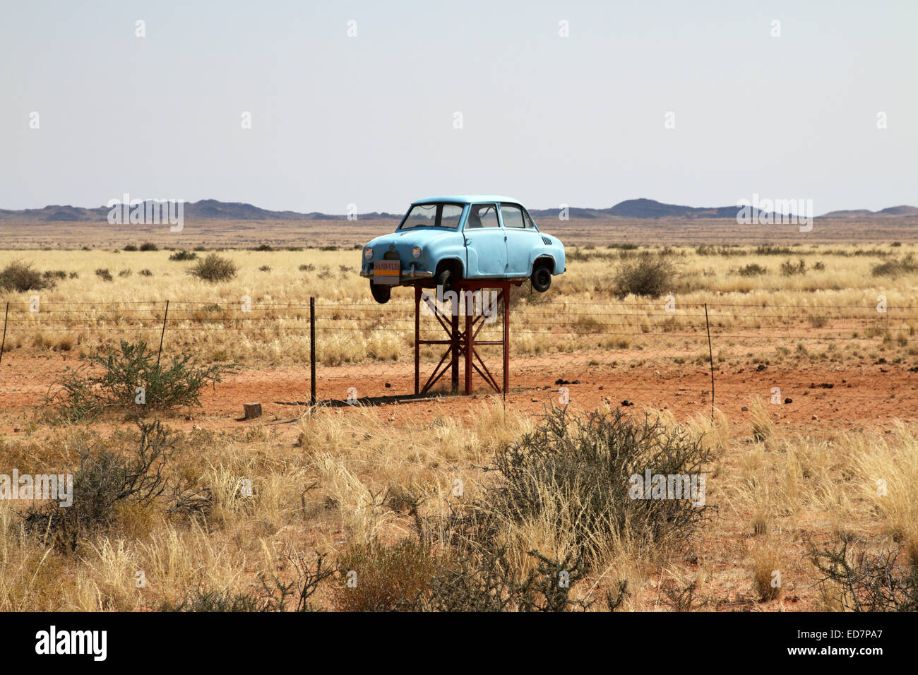 frisky entrance sign an old derelict Fiat in wide open space to a big property and farm near Upington Northern Cape South Africa Stock Photo