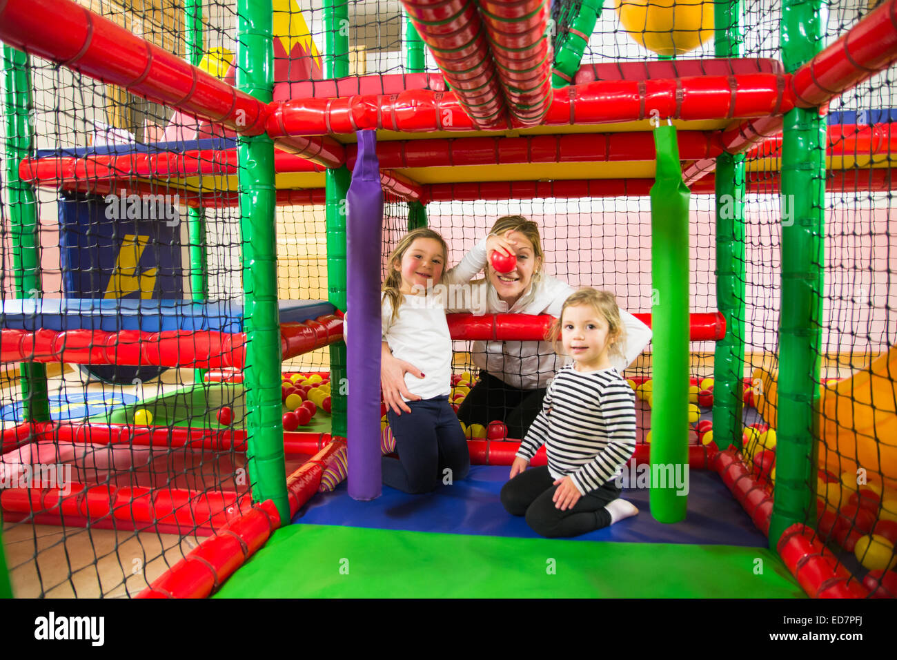 Family into indoor playroom Stock Photo