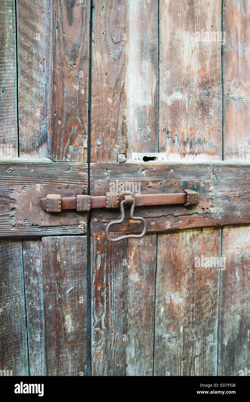 deadbolt on old wooden door Stock Photo Alamy