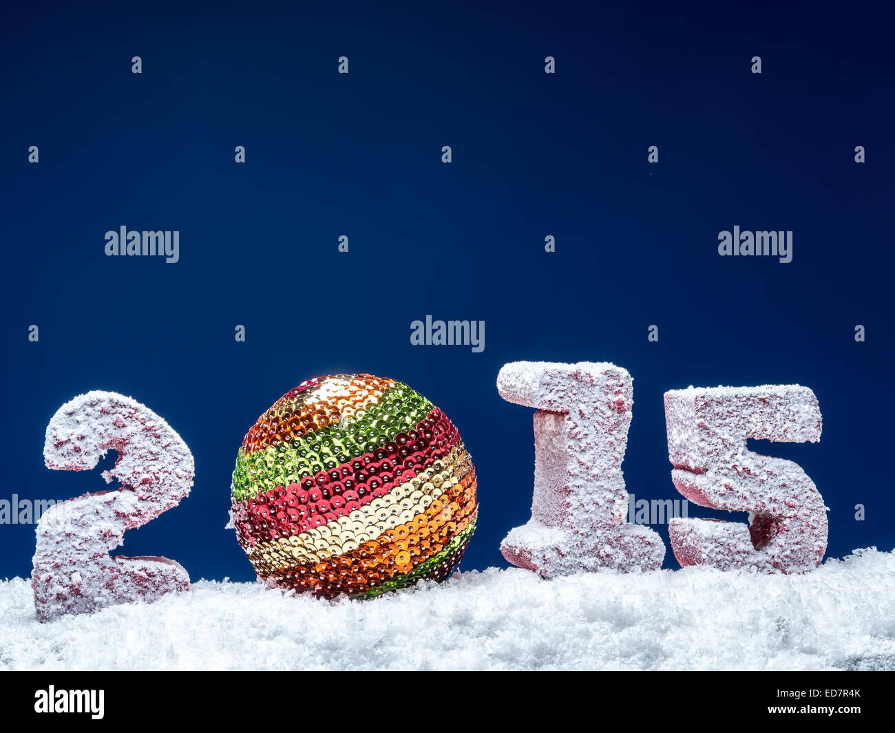 Frosted 2015 New Year digits and glistering ball over dark blue background Stock Photo