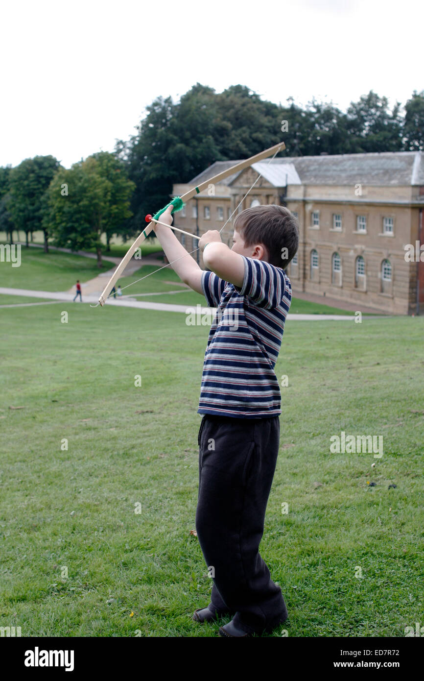 eight year-old boy and his toy bow at Wollaton Park Nottingham Stock Photo