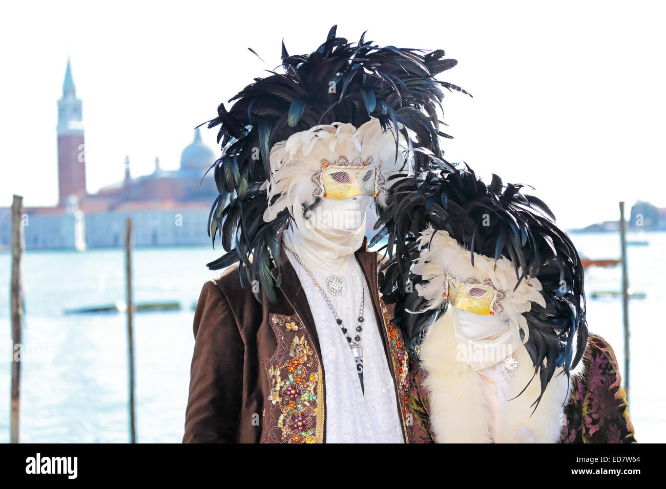 Couple of black and white masks decorated with feathers exhibited during the traditional Carnival of Venice, Italy (2014 edition Stock Photo