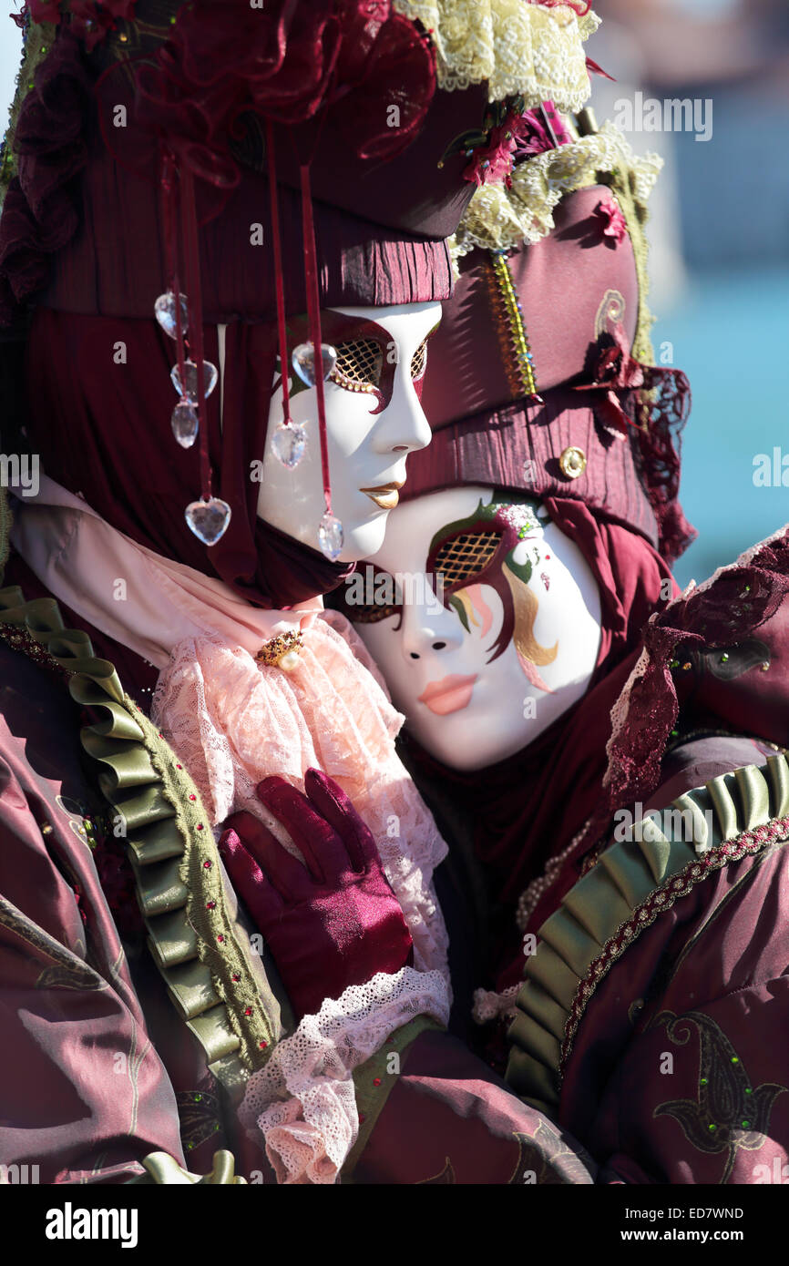 A masked hugging couple exhibited during the traditional festival of Carnival of Venice, Italy (2014 edition) Stock Photo