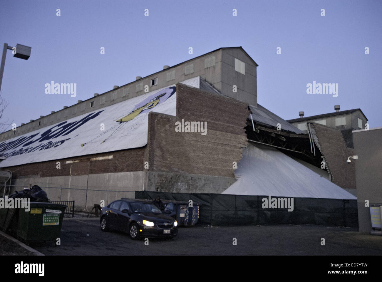 Chicago, Illinois, USA. 31st Dec, 2014. On December 30, 2014, a mountain of salt broke through a wall at the Morton Salt plant in Chicago, spilling into the McGrath Acura car dealership next door. The Sun-Times reported that eleven cars parked at the dealership were buried by the outpouring of the salt. According to Julian Rice, a security guard on duty, the salt continued its downslide today, breaking the back windows and filling a couple of the cars. Preliminary investigation found that the salt inside the building was piled too high, producing the pressure that caused the wall to collap Stock Photo
