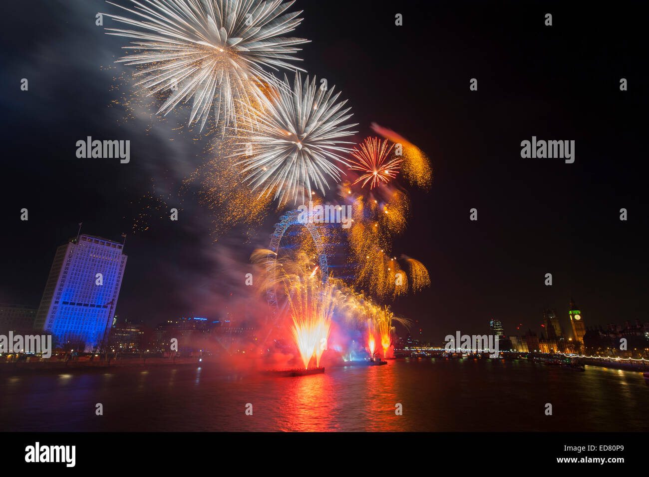 Central London, UK. 1st January, 2015. NYE 2014 firework display, presented by the Mayor of London, centred around the London Eye on the river Thames in central London, watched by a sell-out 100,000 ticket paying spectators. The London NYE fireworks display was produced by London based Jack Morton Worldwide for the 11th consecutive year. Credit:  Malcolm Park editorial/Alamy Live News Stock Photo