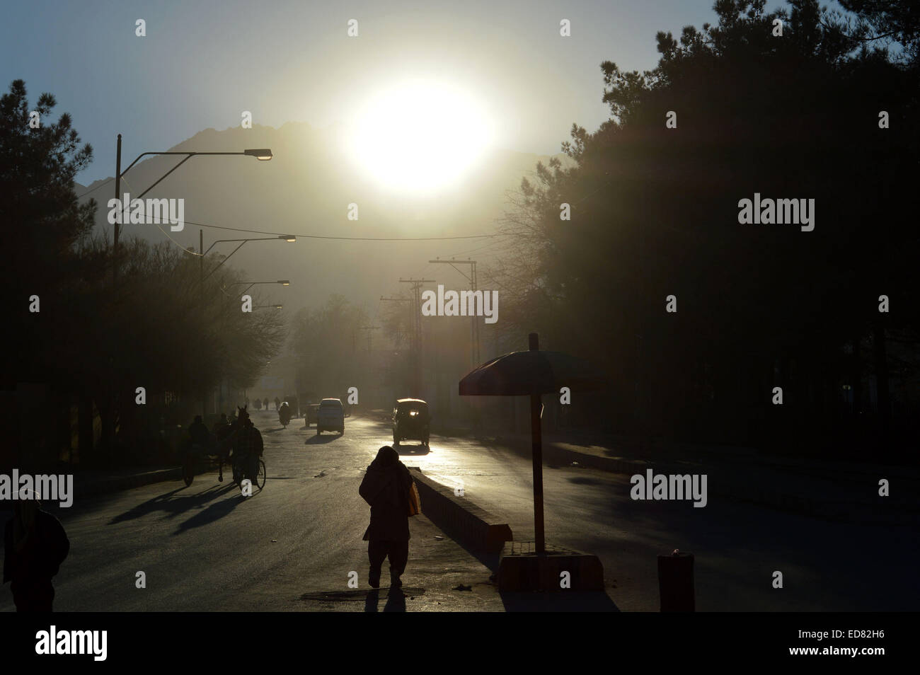 Quetta. 1st Jan, 2015. People cross a road during the first sunrise of