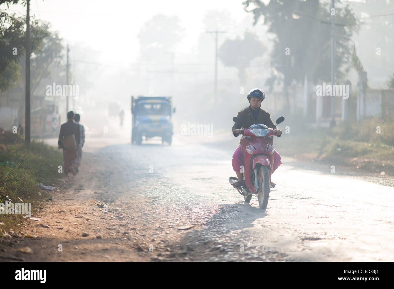 Commuting to work through the early morning smog, Loikaw Stock Photo