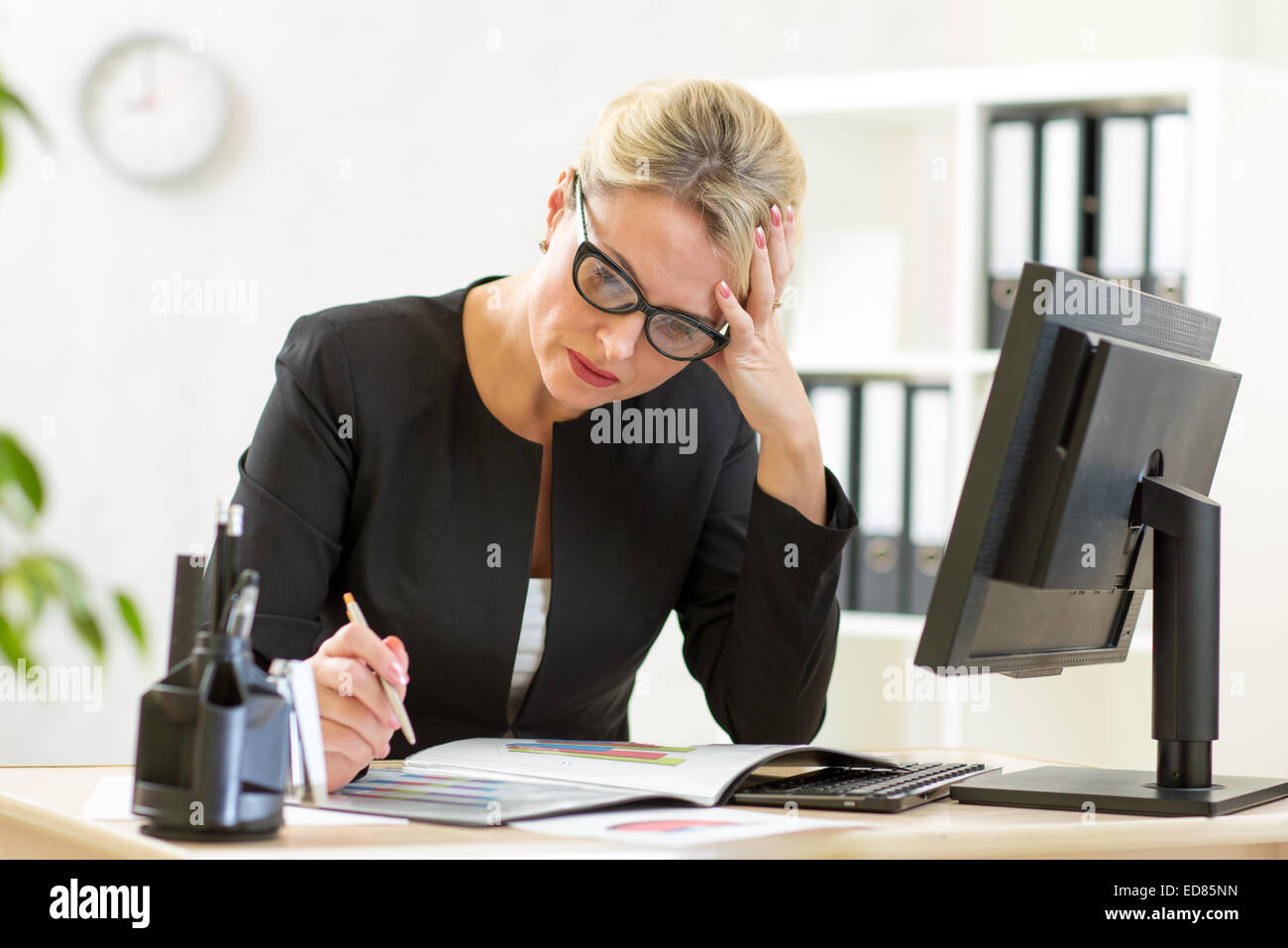 business woman looking at business papers in office Stock Photo