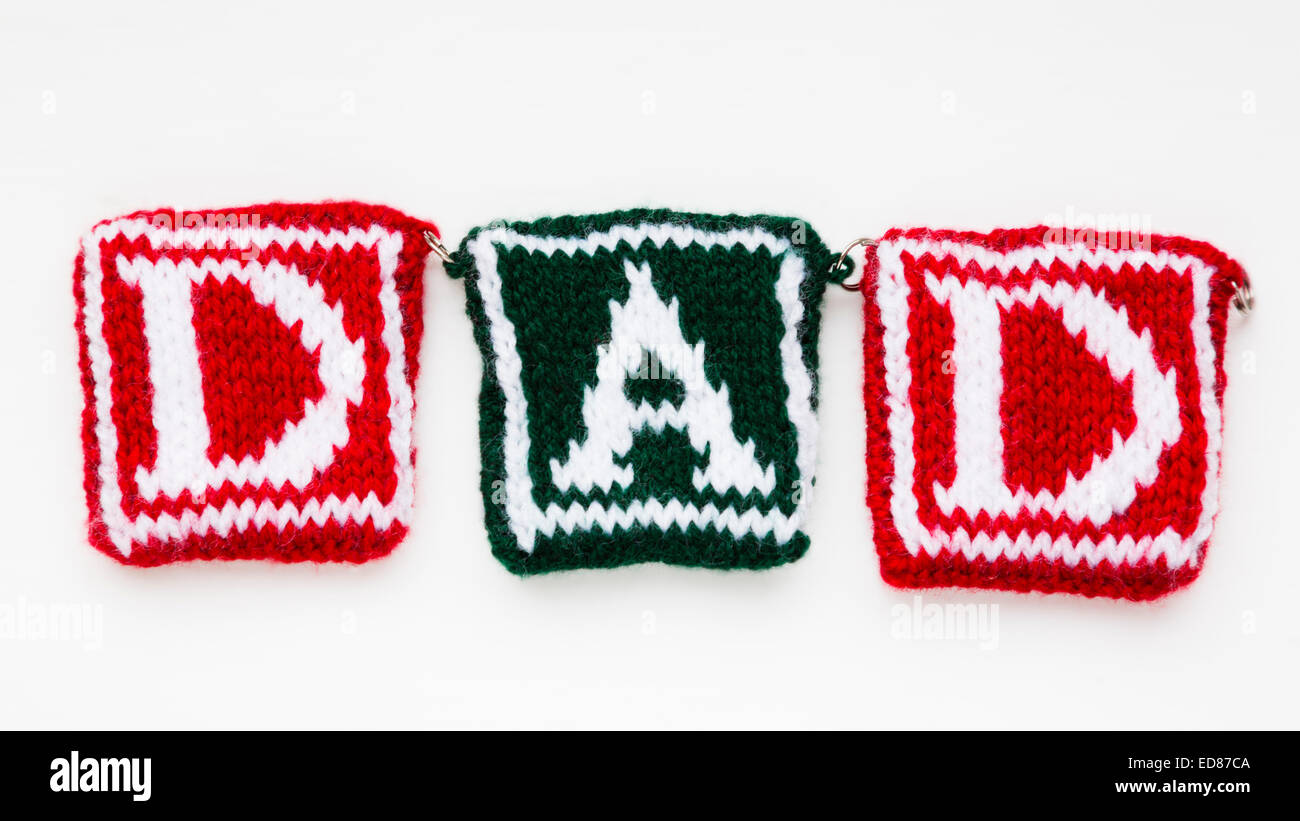 Knitted woollen lettering spelling 'Dad'. Stock Photo