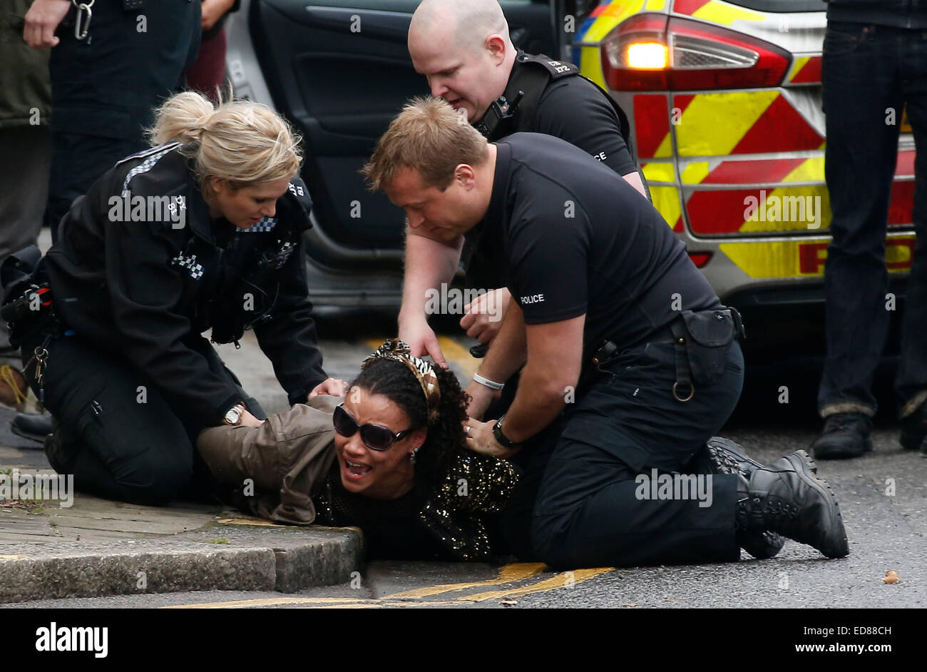 A woman is restrained and arrested by police for being drunk and disorderly. January 1 2015 (Outcome of arrest unknown) Picture by James Boardman. Stock Photo