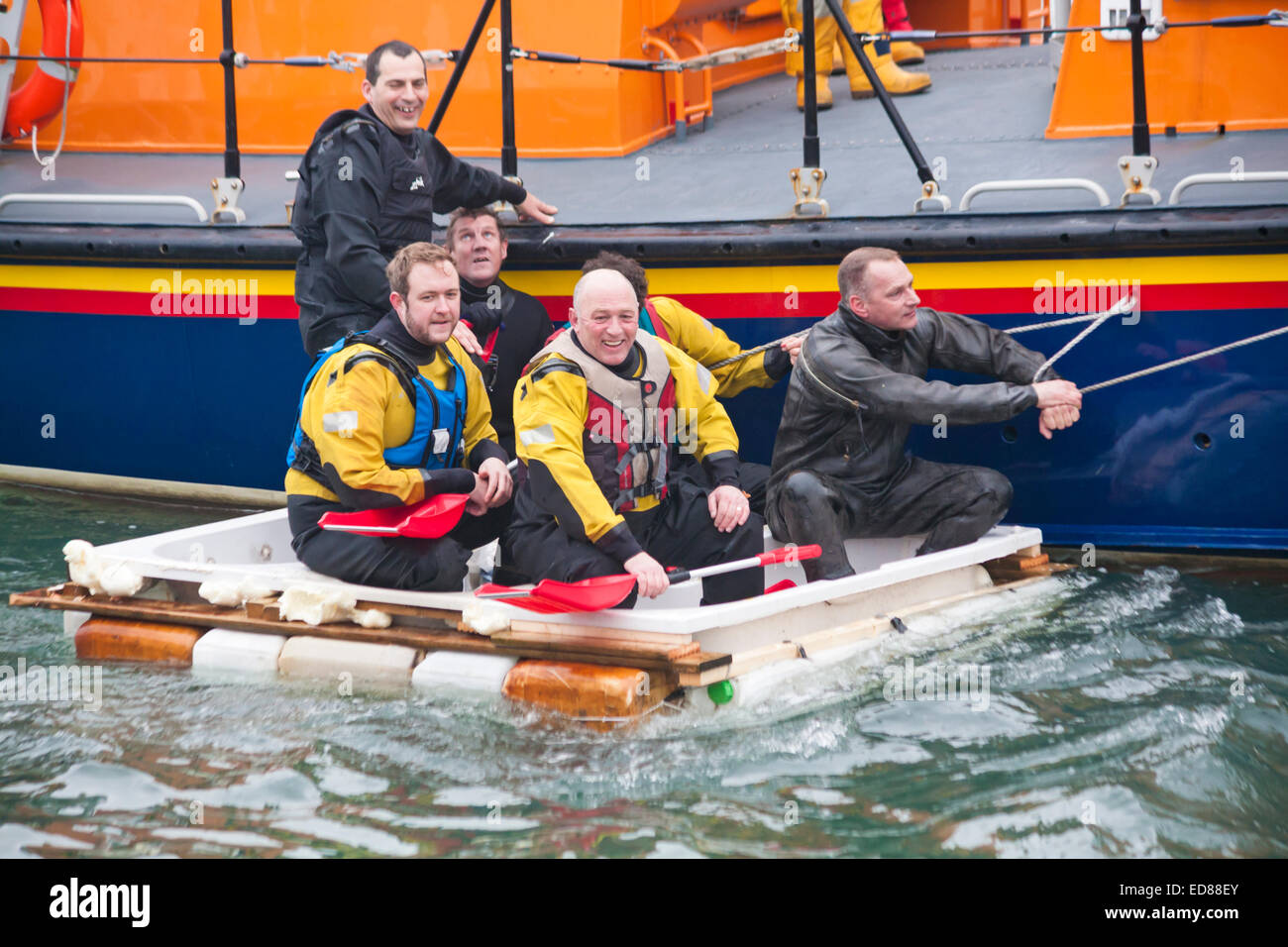 Poole, Dorset, UK. 1st January, 2015. A variety of unusual craft take to the water to race from the steps of The Customs House to the steps of The Lord Nelson and The Jolly Sailor, having fun throwing eggs and flour, firing water cannons and capsizing competing craft. Credit:  Carolyn Jenkins/Alamy Live News Stock Photo