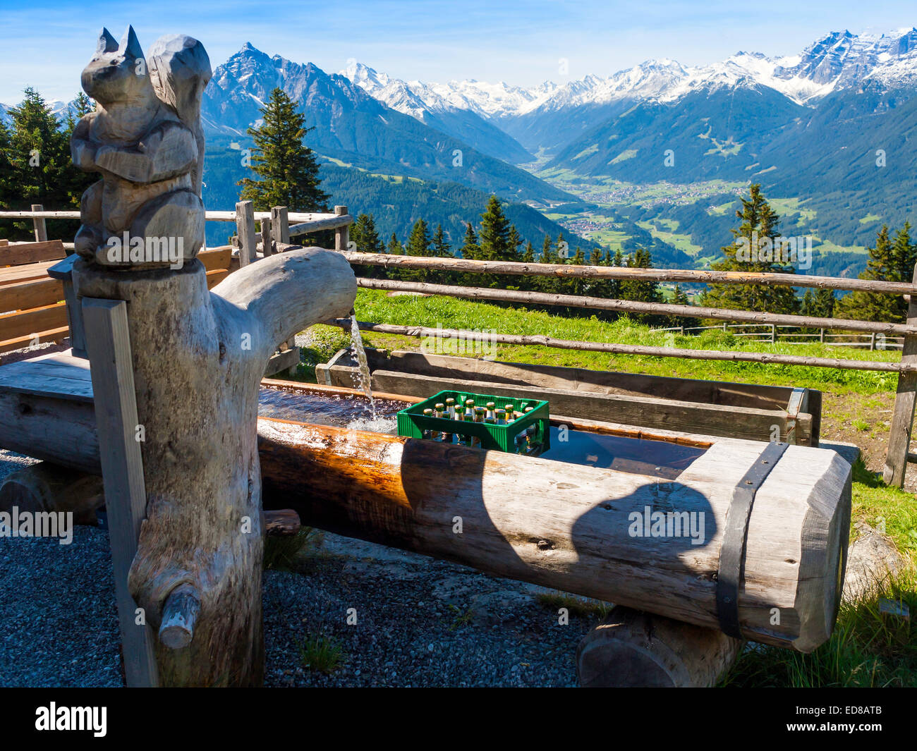 At the Hochmandalm hut in the Austrian Tirol cold mountain water cools beer in the cattle trough Stock Photo