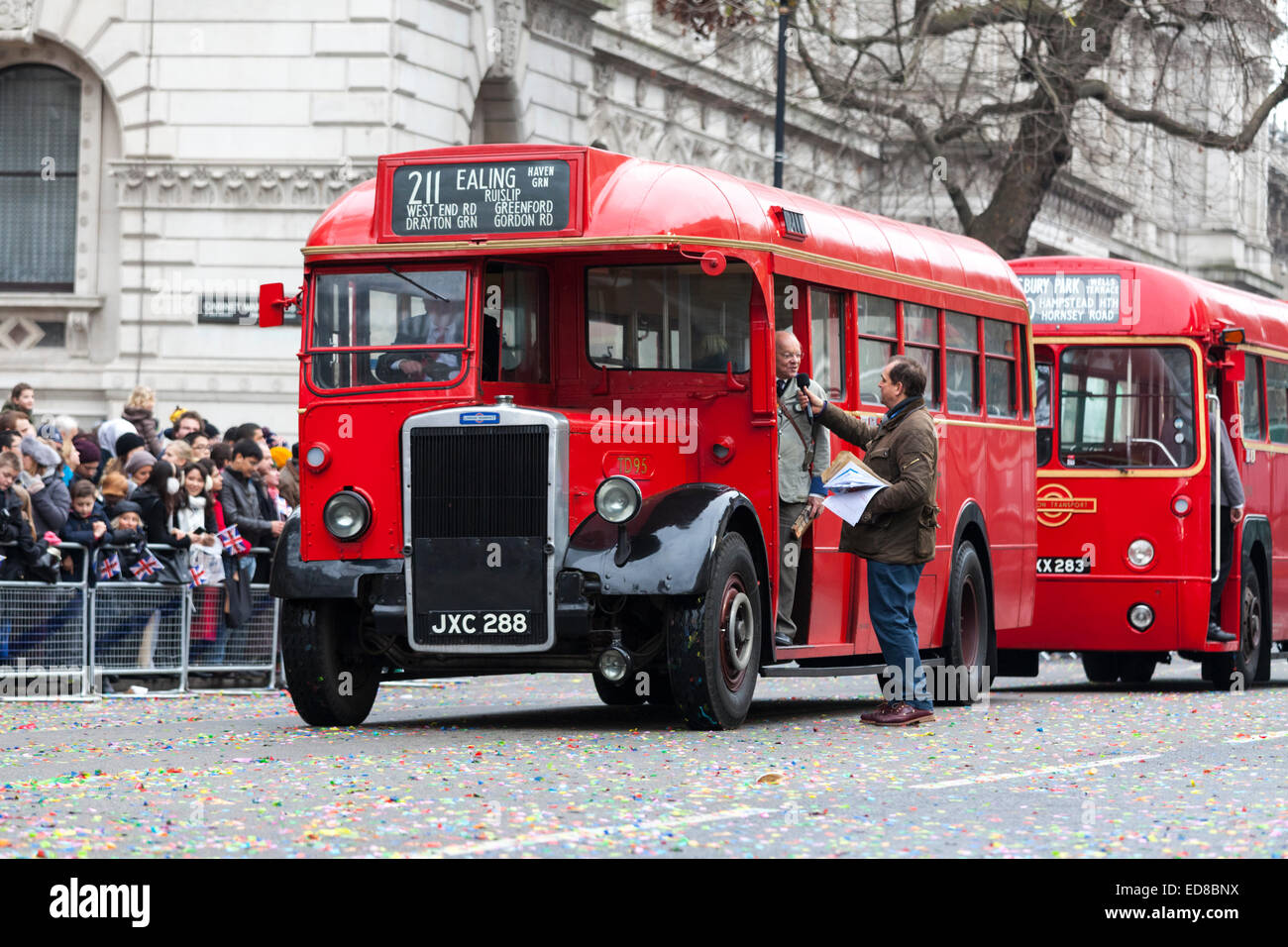 Parade Presenter Jeremy Grittins interviews a participant from London Transport and the London Bus Museum in a historic single decker buses at the London New Year's Day Parade on 1st January 2015. Stock Photo