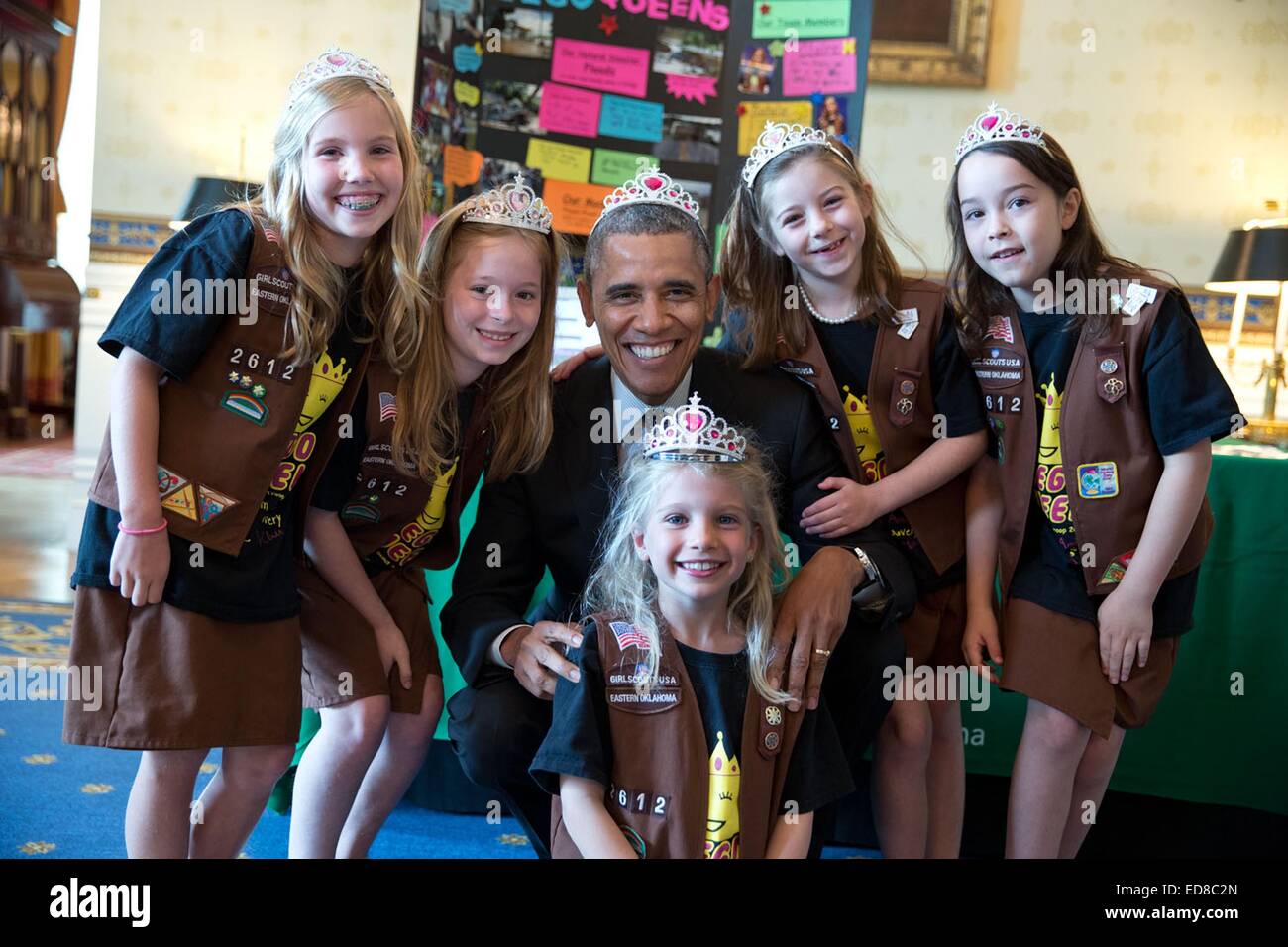 US President Barack Obama dons a princess crown as he poses for a photo with Brownies from Girl Scout Troop 2612 during a visit to their science fair May 27, 2014 in Tulsa, Oklahoma. Stock Photo