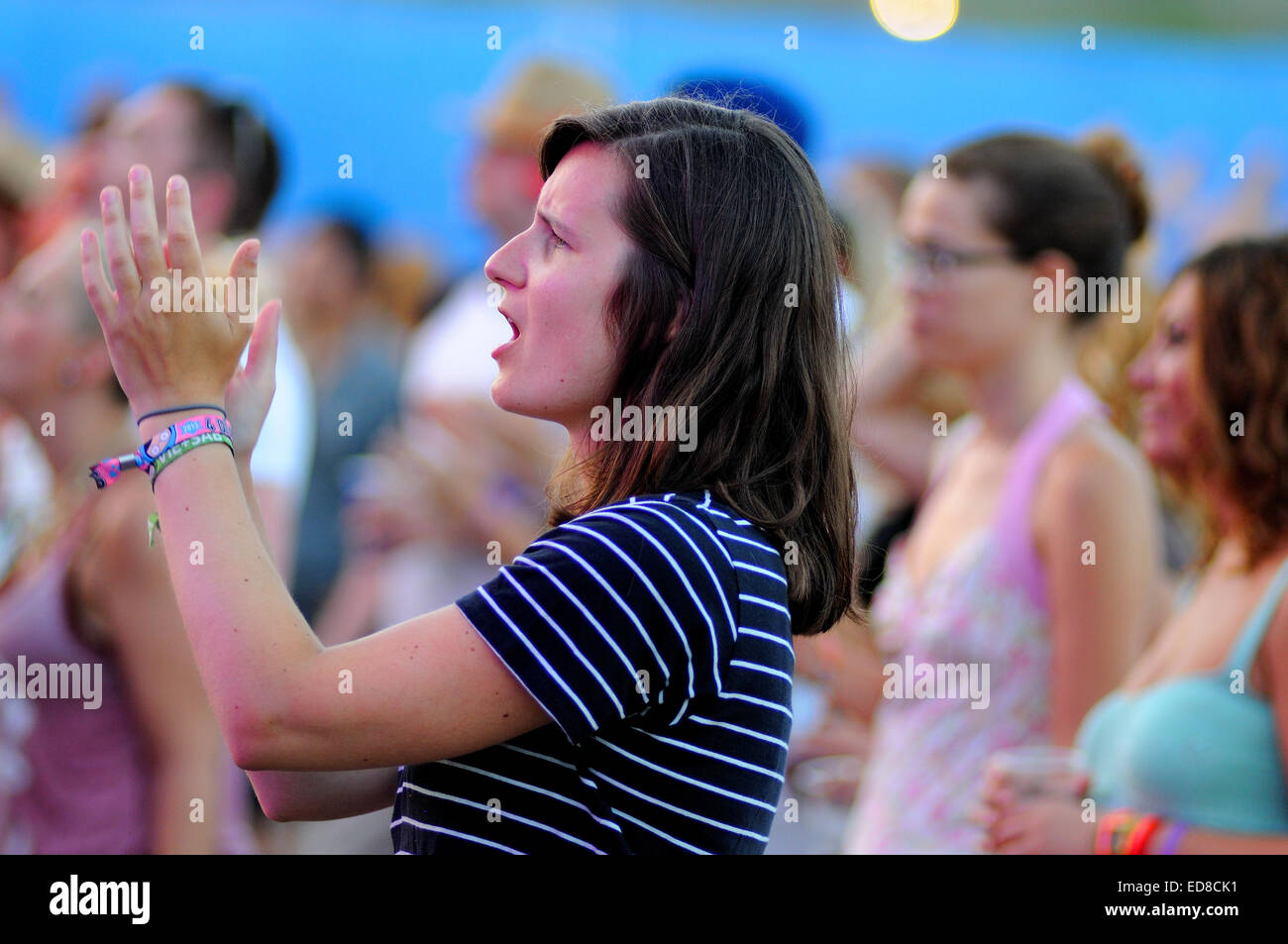 BENICASSIM, SPAIN - JULY 19: A woman from the crowd applauding at FIB (Festival Internacional de Benicassim) 2013 Festival. Stock Photo