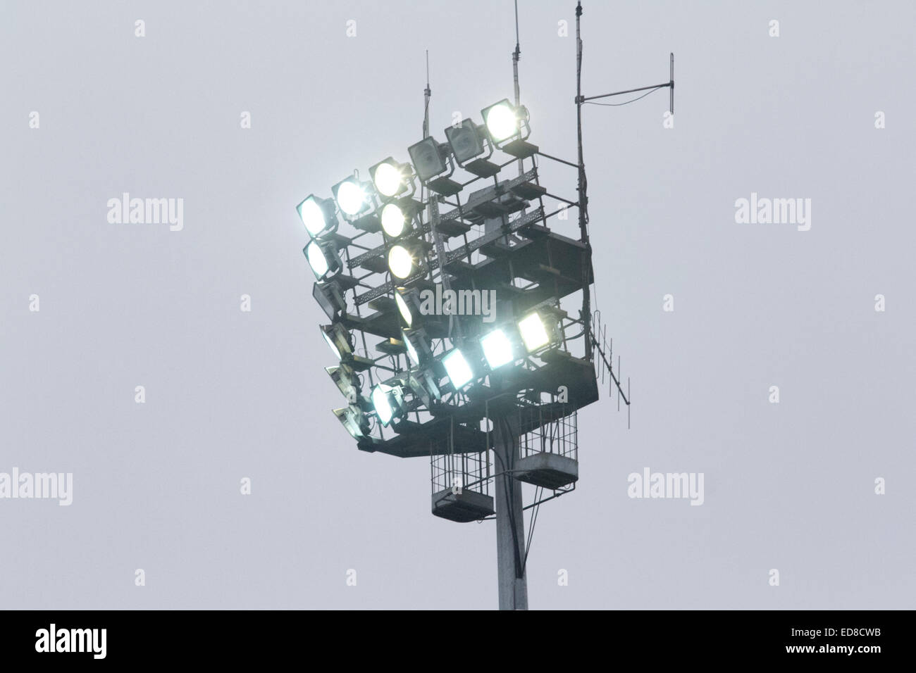 Loftus Road, London, UK. 1st January 2014.  Stadium lights are switched on as fans attend the first English Premier League match of the New Year between Queens Park Rangers and Swansea. Fans arrived wrapped up warm on a cold  winter's day. Credit:  amer ghazzal/Alamy Live News Stock Photo
