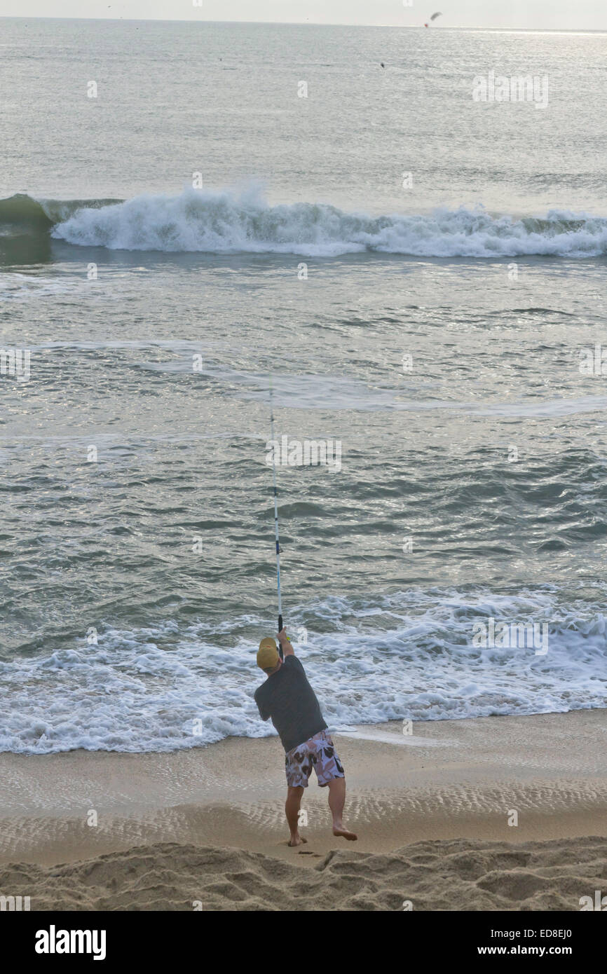 Cape Hatteras, Outer Banks, North Carolina, USA - October 18, 2013:  A man on a beach casts a fishing line into the sea Stock Photo
