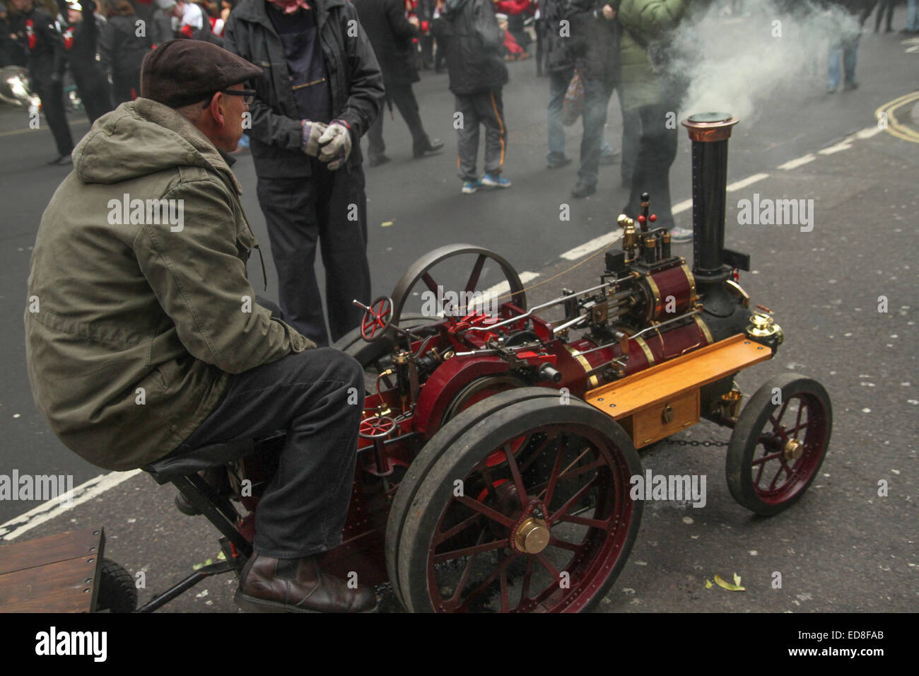 London, UK. 1 January 2015. An operator attends to his mini steam engine. Londoners and tourists turned up in droves for the new years parade. The annual parade goes through Piccadilly, Regents street, Pall Mall and Whitehall a 2 mile route. Photo: David Mbiyu/ Alamy Live News Stock Photo