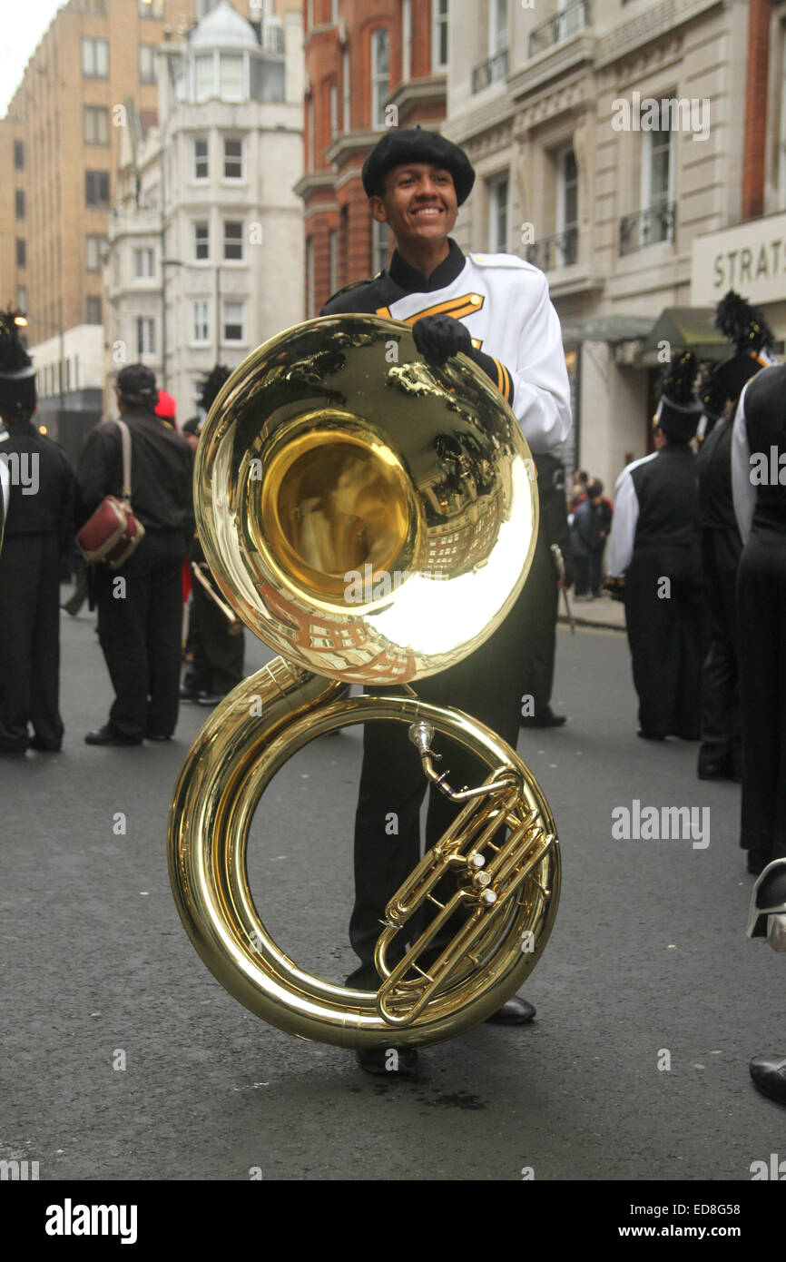 London, UK. 1 January 2015. A band member poses for photos with his brass, as Londoners and tourists turned up in droves for the new years parade. The annual parade goes through Piccadilly, Regents street, Pall Mall and Whitehall a 2 mile route. Photo: David Mbiyu/ Alamy Live News Stock Photo